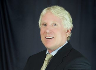 Keys to Beaver: Drop Dead Keys to Beaver: Drop Dead - A man wearing a suit and tie smiling at the camera - Business