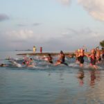 Tri-umphant at MaraTri - A group of people in a body of water - Rowing