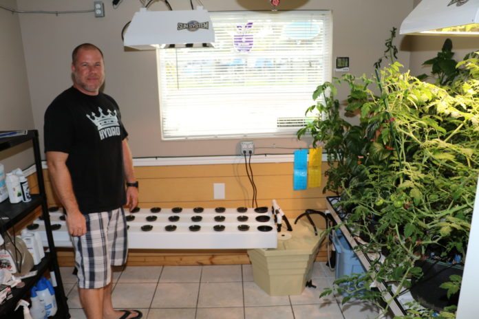 Hydroponics in the Keys - A man standing in front of a computer - Florida Keys