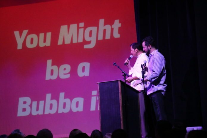 You might be a Bubba… - A man standing on a stage in front of a sign - Public Relations