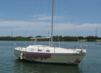 County launches vessel turn-in program - A small boat in a body of water - Sail