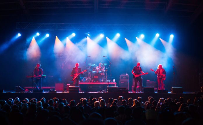 HELP WANTED: BOOKING AGENT FOR AMPHITHEATER - A group of people on a stage in front of a crowd - MECU Pavilion