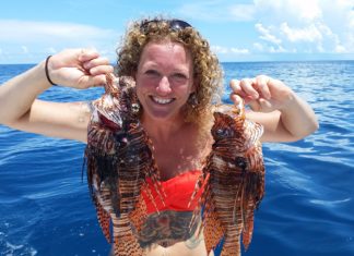 Multi-tasking with Rachel Bowman - A person standing next to a body of water - Red lionfish