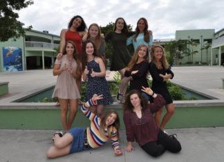 Meet the Miss Coral Shores finalists - A group of people sitting on a bench posing for the camera - Coral Shores High School