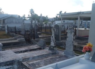 Livening up the cemetery – Efforts are underway by many to fix-up land mark Livening up the cemetery – Efforts are underway by many to fix-up land mark - A train is parked on the side of a building - Roof