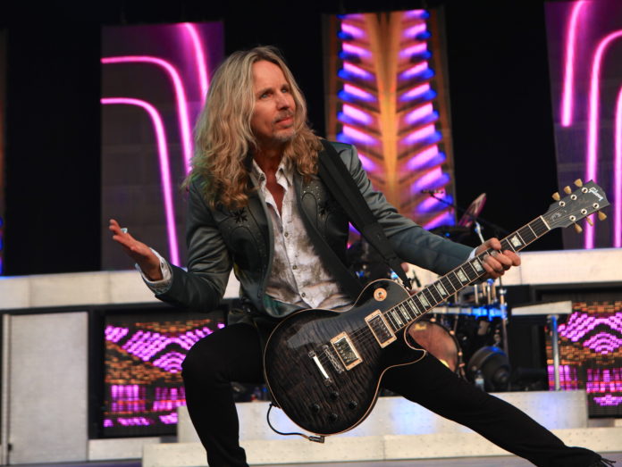 ON A ‘MISSION’ - Tommy Shaw with a guitar on a stage - Tommy Shaw