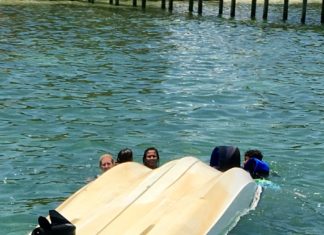 Local rescues 5 children from capsized boat - A group of people swimming in the water - Florida Keys