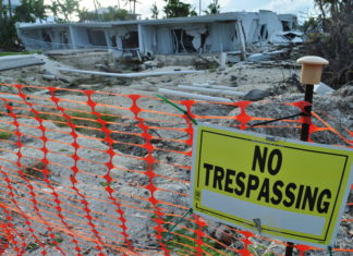AT RISK – Lower Matecumbe especially vulnerable this hurricane season - A sign in front of a fence - Lower Matecumbe Key