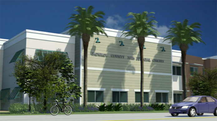 Ready for rebuild – BOCC to staff: Plantation Key courthouse project urgent - A group of palm trees on the side of a building - Plantation Key