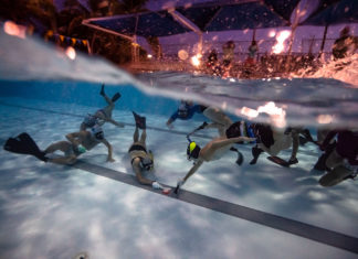 UNDERWATER CONFIDENCE - A group of people playing instruments and performing on a stage - Water