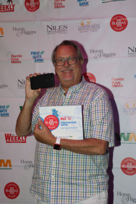 And the Winners Are! - A man holding a sign - Key West Theater