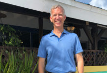 Charles “Chuck” Licis works  tirelessly for Take Stock - A man in a blue shirt standing in front of a building - Florida Keys