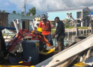 Canal cleanup begins in all areas - A group of people standing on a boat - Key West