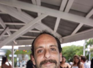 Heads Up Key West – Tom Flip portraits capture locals again - A man holding a camera - Shel Silverstein