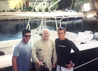 John McCain et al. standing on a boat posing for the camera - Niall Horan