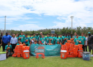 Dolphins to Dolphins – NFL foundation makes huge donation to MHS - A group of people posing for the camera - Car