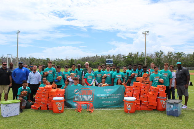 Dolphins to Dolphins – NFL foundation makes huge donation to MHS - A group of people posing for the camera - Car