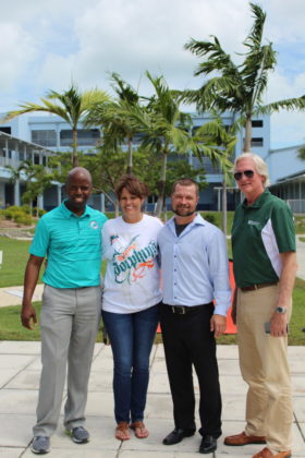 Dolphins to Dolphins – NFL foundation makes huge donation to MHS - A group of people standing in front of a tree posing for the camera - Social group
