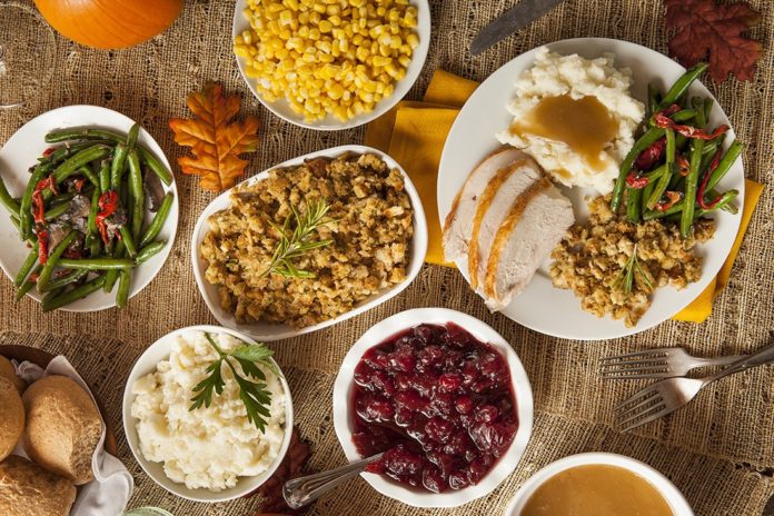 Thanksgiving guide – Where to volunteer, or find a turkey dinner - A bowl filled with different types of food on a table - Thanksgiving dinner