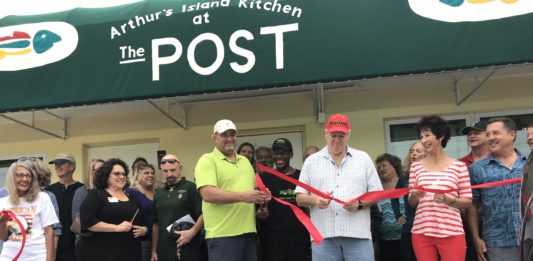 A NEW BEGINNING – VFW Post opens in Key Largo - A group of people standing in front of a crowd posing for the camera - Key West