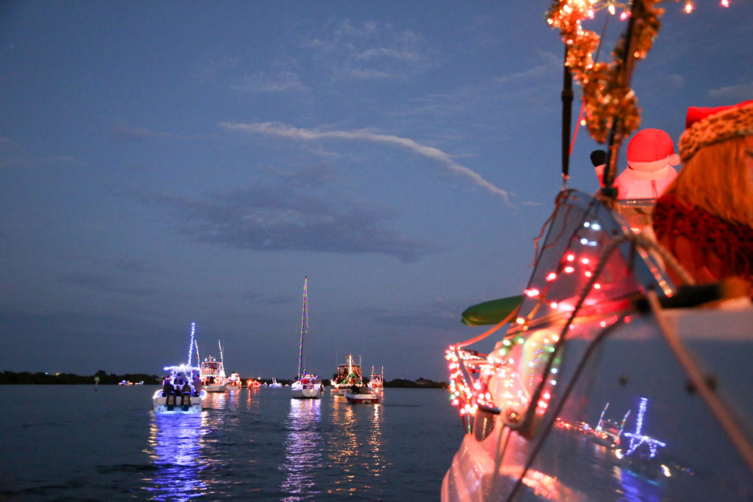 Holiday Boat Parades You Don’t Want to Miss - A group of people on a boat in the water - Boat parade