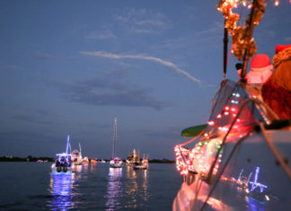 Holiday Boat Parades You Don’t Want to Miss - A group of people on a boat in the water - Boat parade