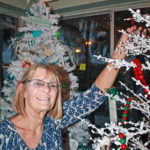 Zonta Club hosts annual event - A woman standing in a room - Christmas tree