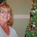 Zonta Club hosts annual event - A person wearing glasses and smiling at the camera - Christmas tree