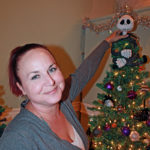 Zonta Club hosts annual event - A person holding a christmas tree - Christmas tree