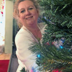 Zonta Club hosts annual event - Christabel Savalas standing in front of a christmas tree - Christmas tree