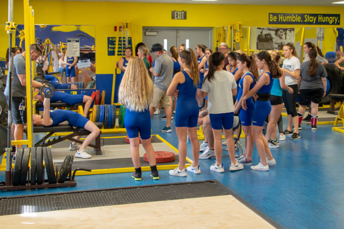 Girls start weightlifting season – MHS faces first-timers CSHS - A group of people playing instruments and performing on a counter - Fitness Centre