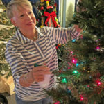 Zonta Club hosts annual event - A person holding a birthday cake - Christmas tree