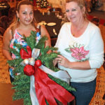 Zonta Club hosts annual event - Keris Kuwana sitting at a table with a vase of flowers - Christmas tree
