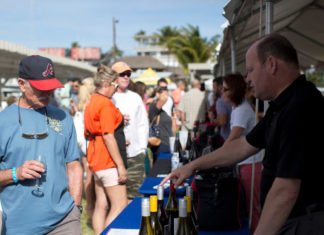 Uncorked Food & Wine Festival This Weekend! - A group of people standing in front of a crowd - Car