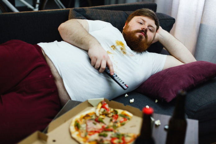 Top 10 Ways to Lose Weight in the Keys (sort of). - A man sleeping on a pizza - Obesity