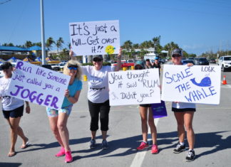 Scale the Whale! Whale Harbor Bridge Run Feb. 9th - A group of people holding a sign posing for the camera - Parade