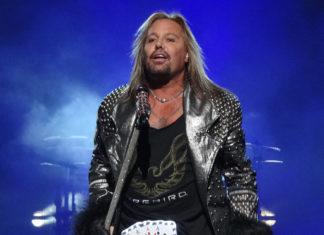 Vince Neil standing in front of a stage - Vince Neil