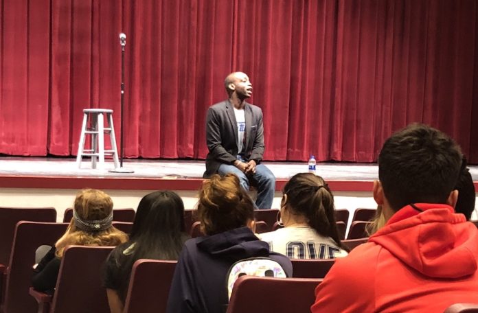 From Here to “Heaven”: Rowan Ricardo Phillips visits Key West High School - A group of people standing in front of a curtain - Academic conference