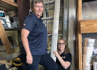 Meet the women of Keys All Area Roofing - A man and a woman standing in front of a building - Job