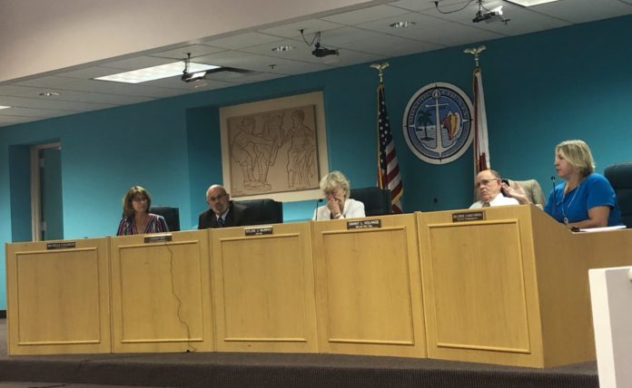 County Commission: Everything You Need to Know from Wednesday’s BOCC Meeting - A group of people standing in a kitchen - Seminar