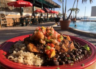 Sunset Grille celebrates 9 years - A plate of food with rice meat and vegetables - Sunset Grille & Raw Bar