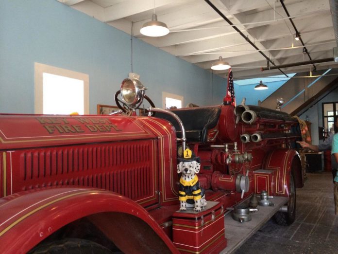 The Bucket List – Local Picks for Best of Key West - A red and black truck sitting on top of a table - Key West Firehouse Museum