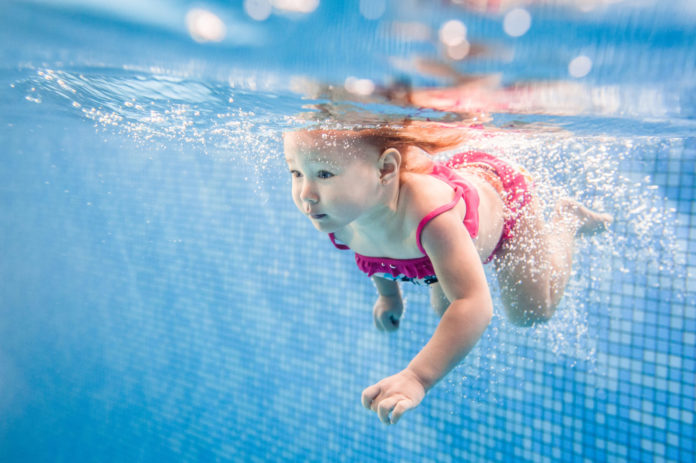 Water Babies! Infant Swim and Survival Classes now offered in Marathon and Key West - A young girl in a pool of water - Swimming