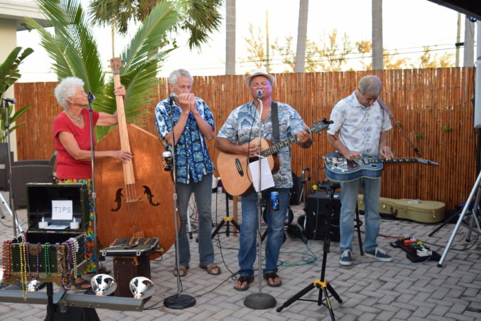 Four Sheets to the Wind brings unique sound - A group of people that are standing in the street - Musician