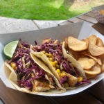 Food truck finds: Check out the Blind Pig - A sandwich sitting on top of a plate of food on a table - Korean taco