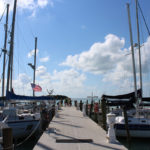 HIGH ADVENTURE - A boat is docked next to a body of water - Florida National High Adventure Sea Base, Boy Scouts of America