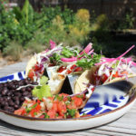 Keys Eats: Bad Boy Burrito - A plate of food on a picnic table - Salad