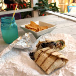 Keys Eats: Bad Boy Burrito - A sandwich sitting on top of a wooden table - Bad Boy Burrito