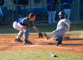 Marathon High baseball team begins season - A baseball player swinging a bat at a ball - Catcher