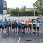 Cyclists go 125 miles to support children’s shelter - A group of people standing in a parking lot - Road bicycle racing